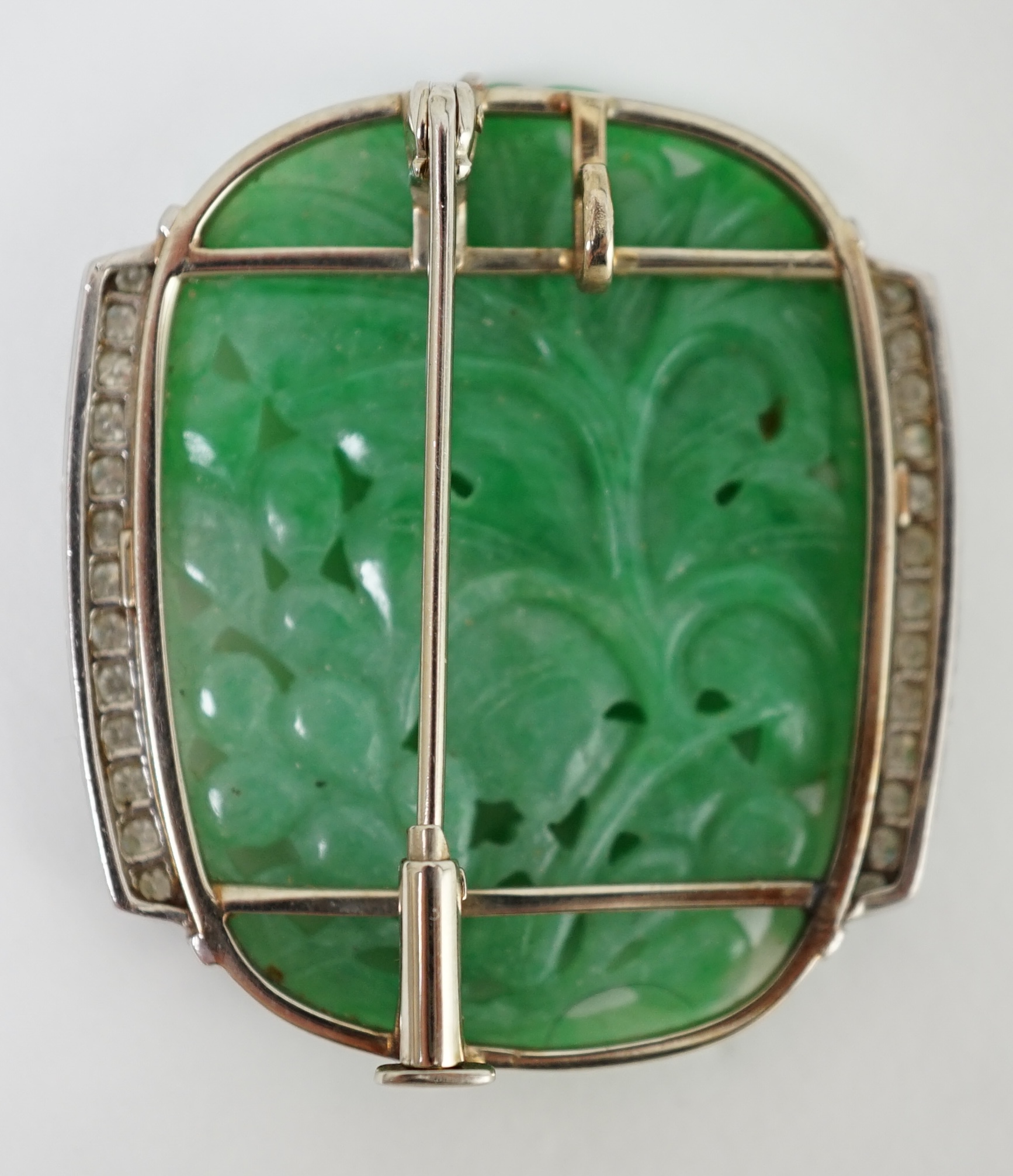 A Chinese white gold and diamond cluster set carved jade leaf and fruit brooch